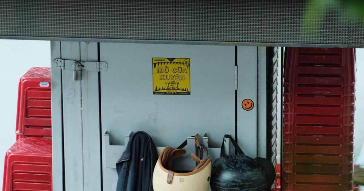 Work jacket, hard hats and bags hanging on a site storage door