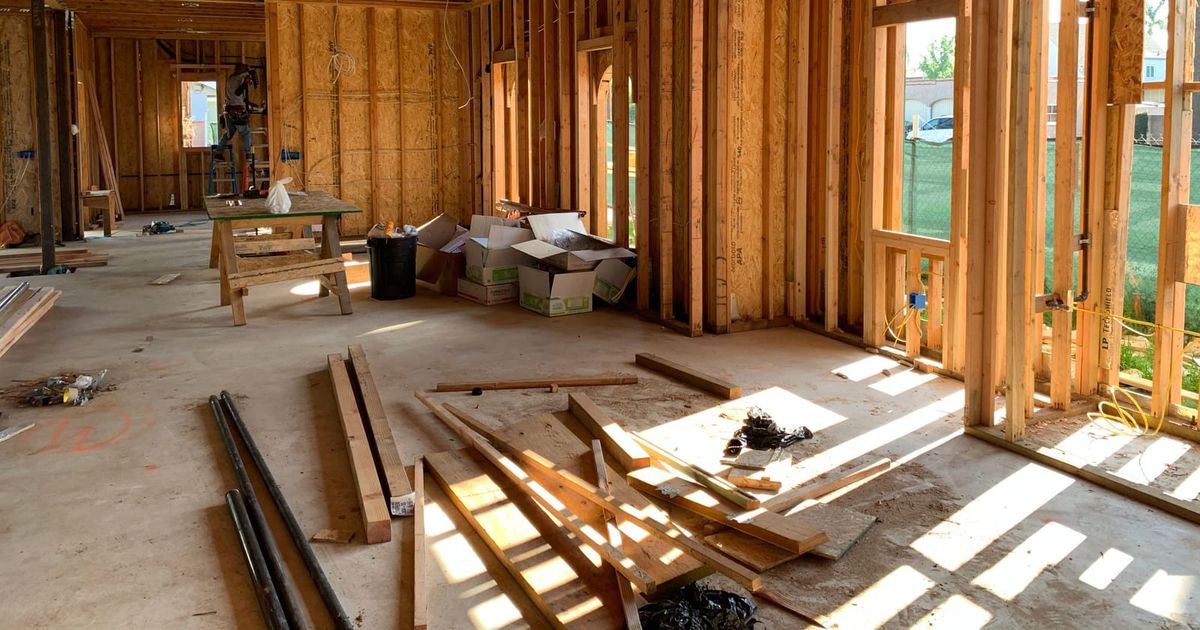 Sunlit house interior with new timber wall framing during construction