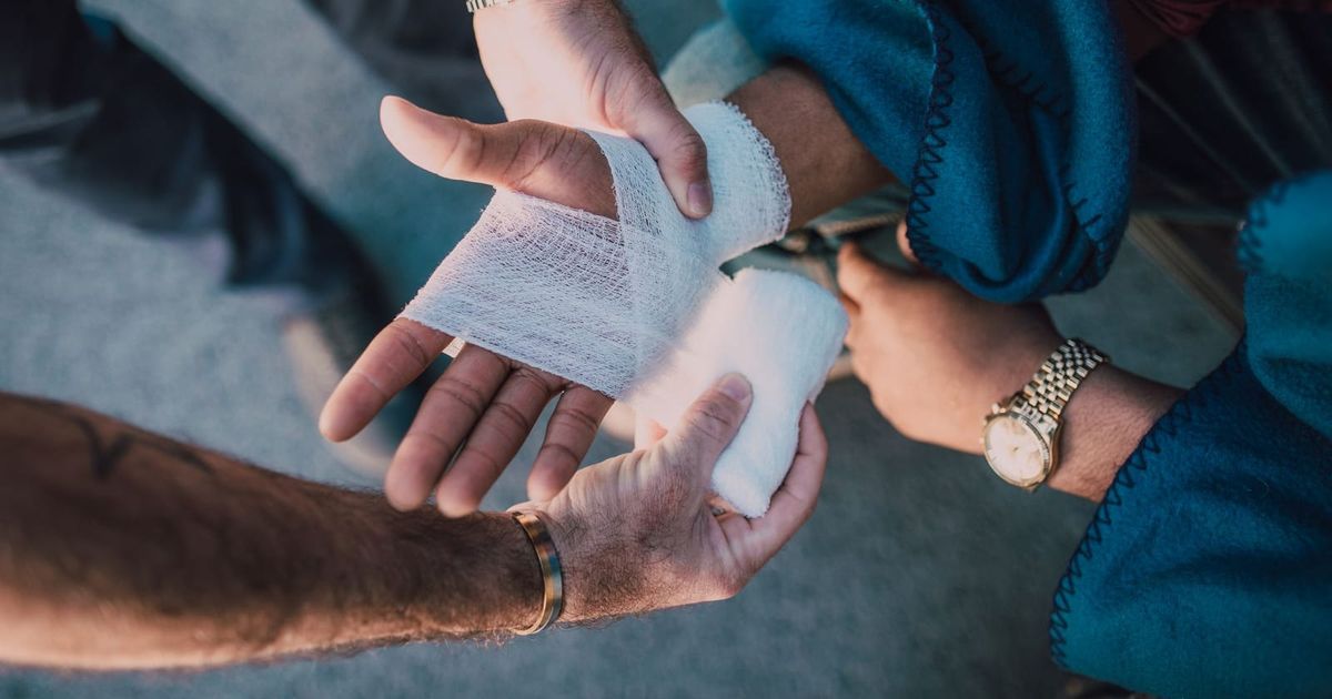 Bandage being wrapped around an injured hand