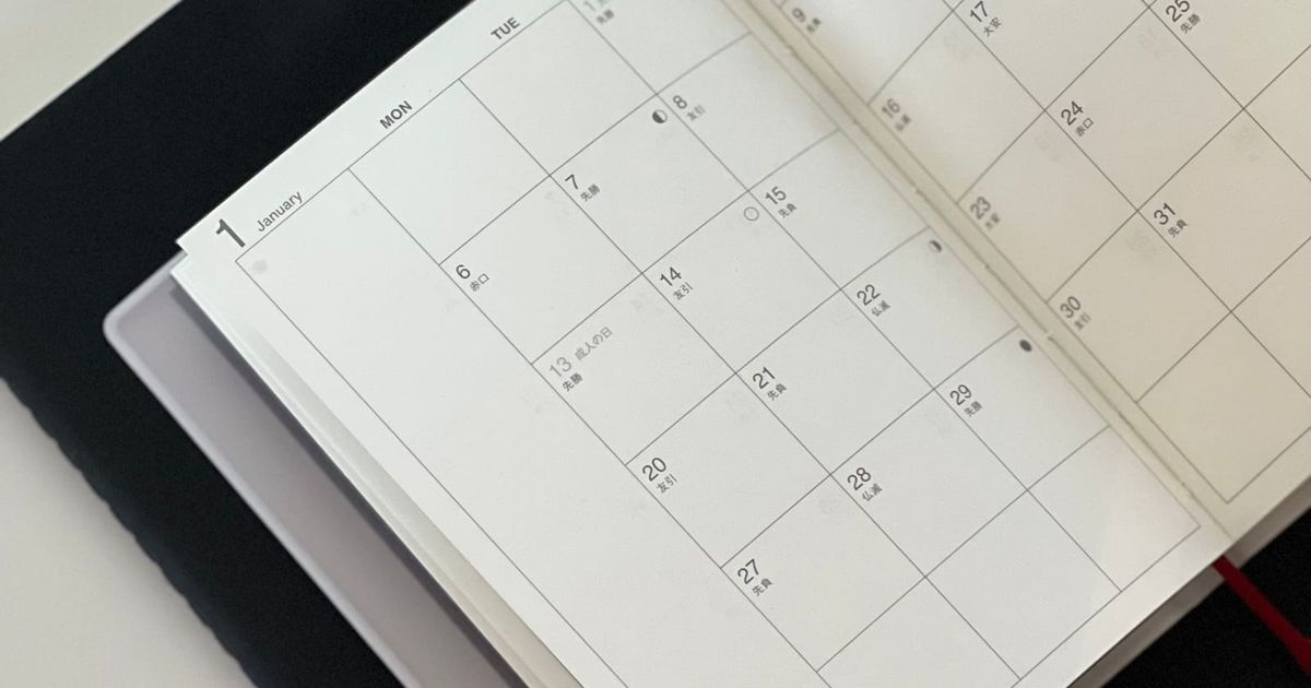 Open planner with a monthly calendar on a desk