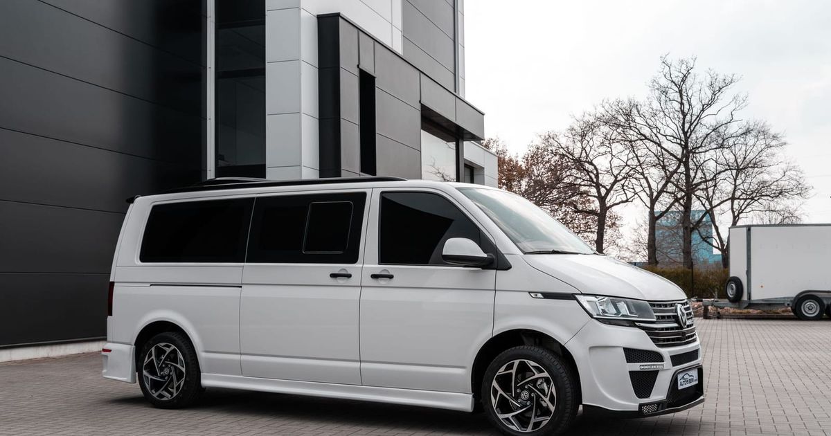 White van parked in front of a building